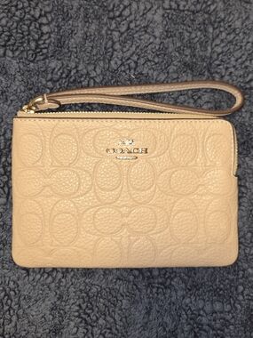 EUC Coach Embossed Leather Wristlet in Beige